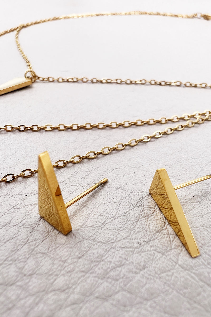 golden layered necklace with triangle, V shape and spike pendants