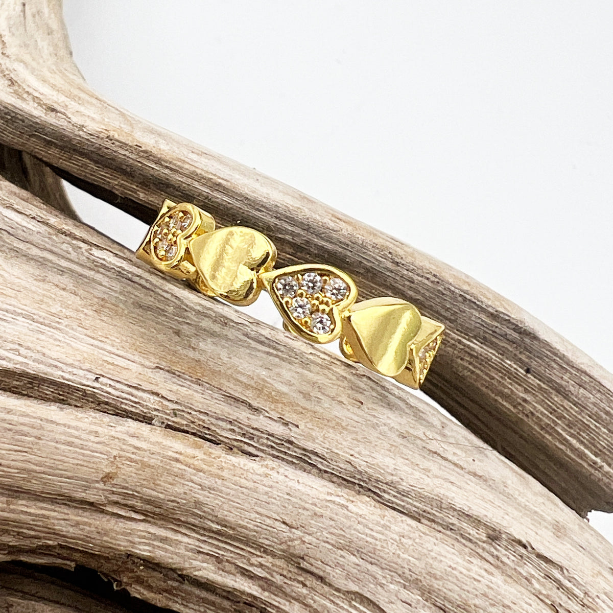 Gold-plated stainless steel rings with CZ-studded heart designs. Adjustable, waterproof, and hypoallergenic.