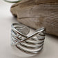 Silver ring on a textured surface with a blurred background