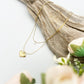 layered gold necklace with cubic zirconia and golden heart