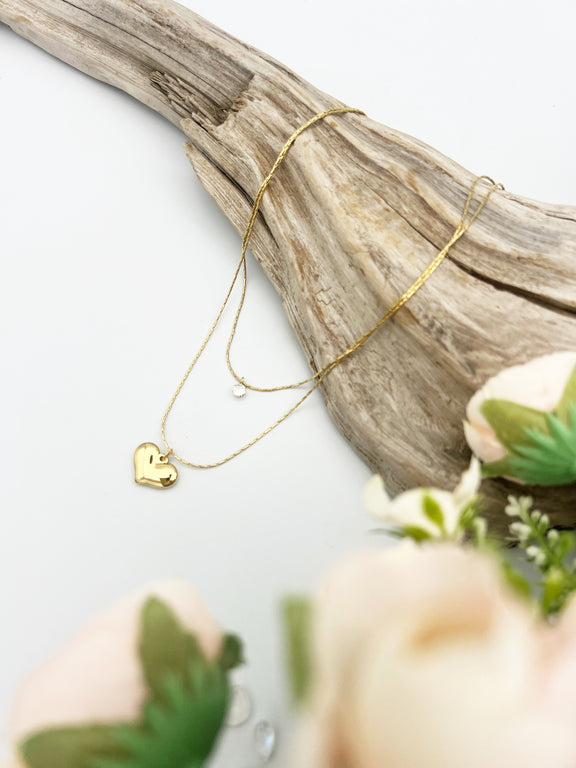 layered gold necklace with cubic zirconia and golden heart