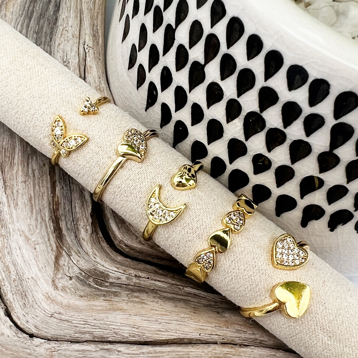 Gold-plated stainless steel rings with CZ-studded heart, butterfly, and moon designs. Adjustable, waterproof, and hypoallergenic.