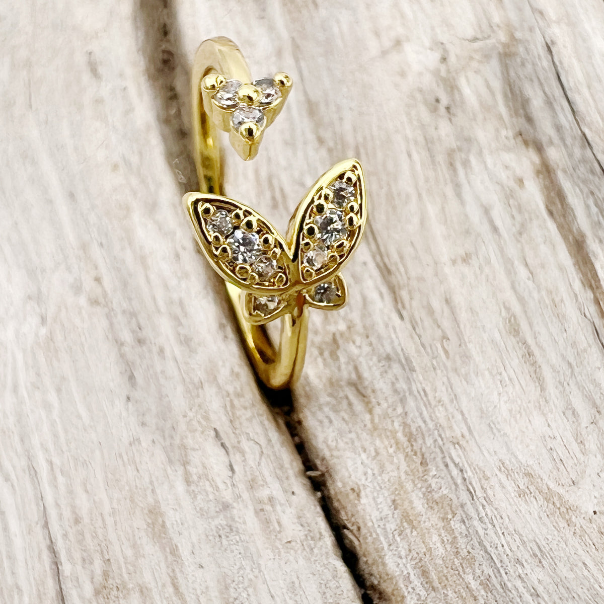Gold-plated stainless steel rings with CZ-studded butterfly. Adjustable, waterproof, and hypoallergenic.