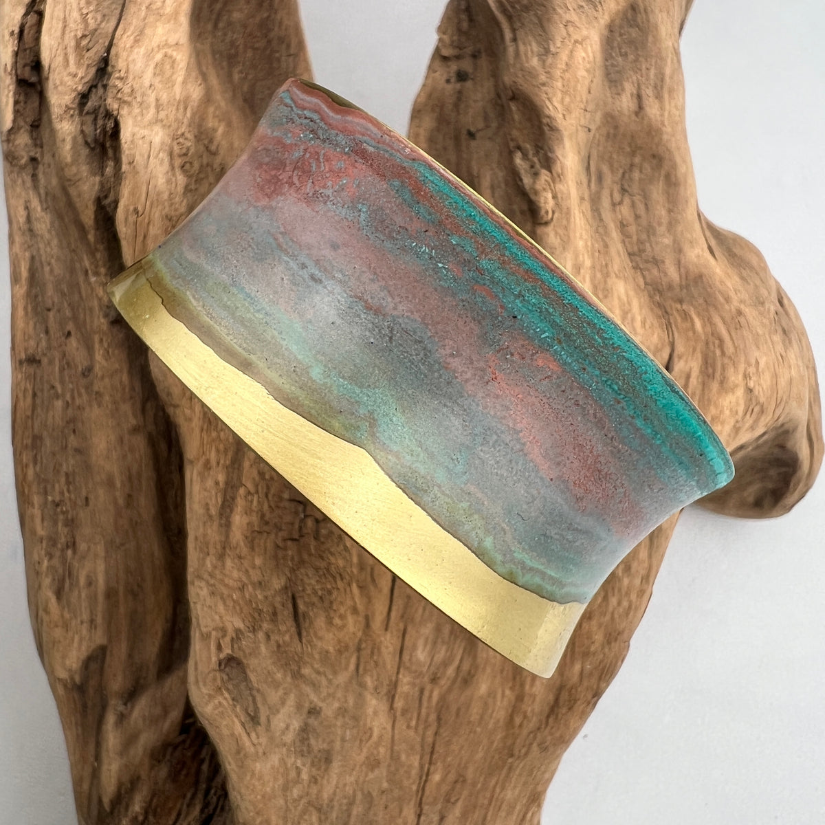 turquoise patina bracelet on a wooden display