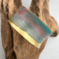 turquoise patina bracelet on a wooden display