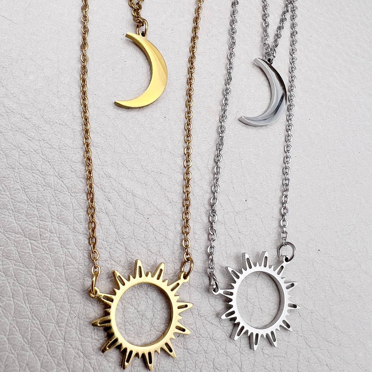 Double-layered 14k gold-plated stainless steel necklace with a sun and moon charm. Waterproof, tarnish-resistant, and perfect for layering.