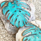 Vivacious modern boho statement jewelry – handcrafted blue patina monstera leaf earrings, a bold and artistic design from Real to the Roots Jewelry. 