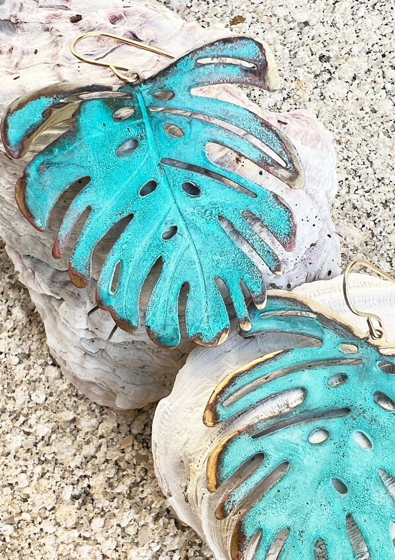 Vivacious modern boho statement jewelry – handcrafted blue patina monstera leaf earrings, a bold and artistic design from Real to the Roots Jewelry. 
