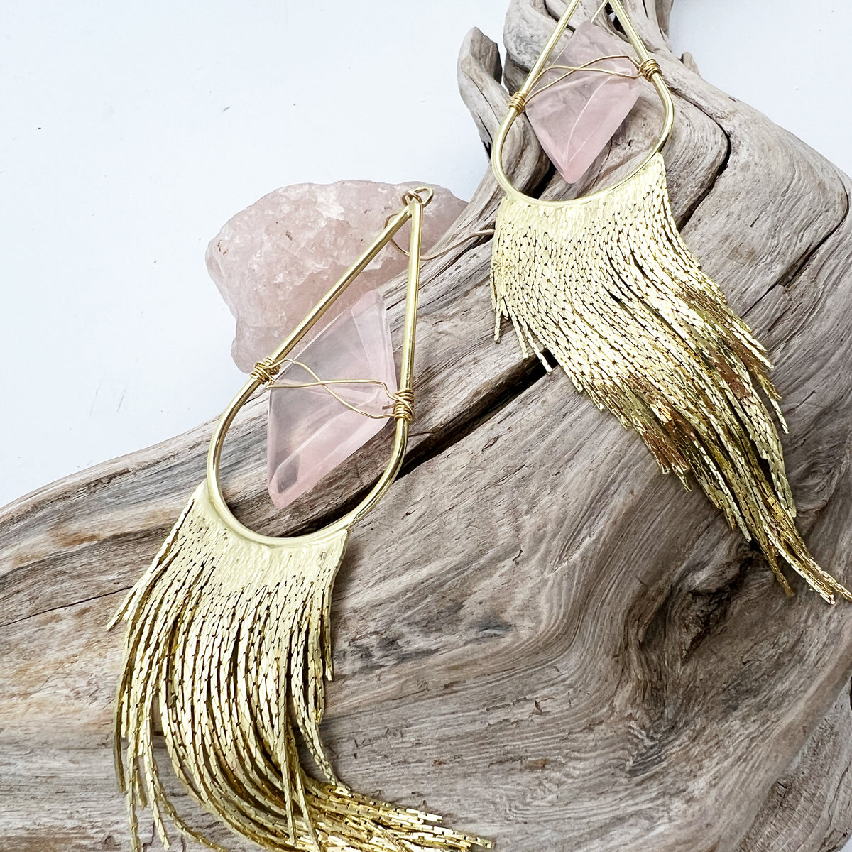 Fancy gold fringed earrings with a diamond shaped rose quartz. 