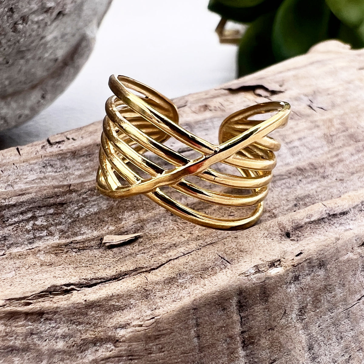 golden statement ring on wood