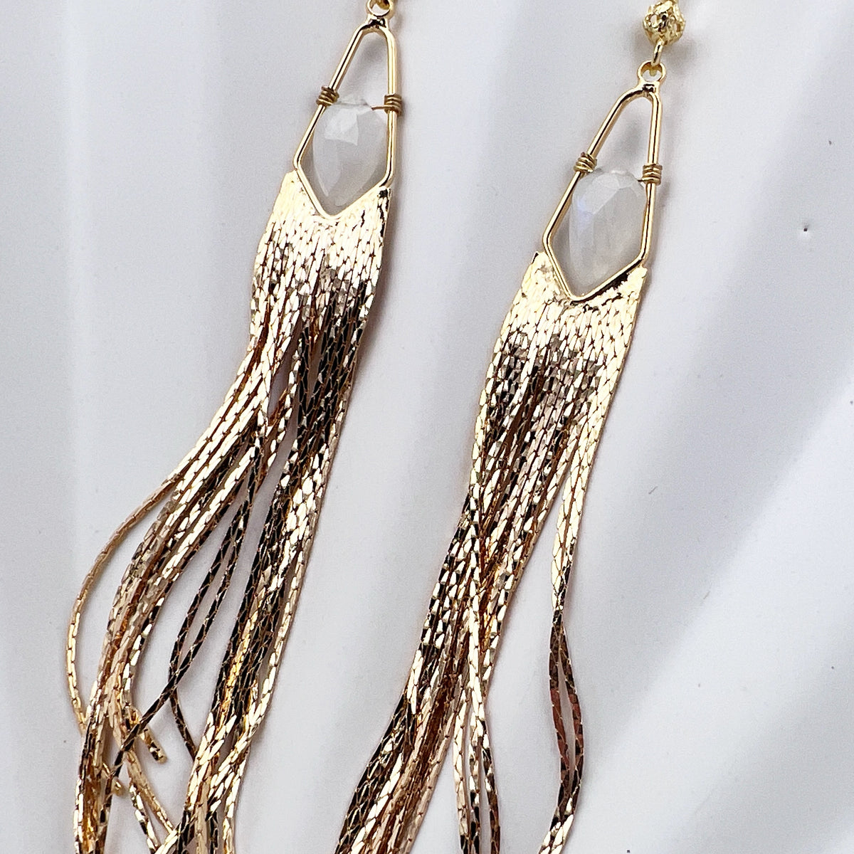 Long gemstone fringe earrings with gold or silver tassels, featuring moonstone. Lightweight and shimmering.