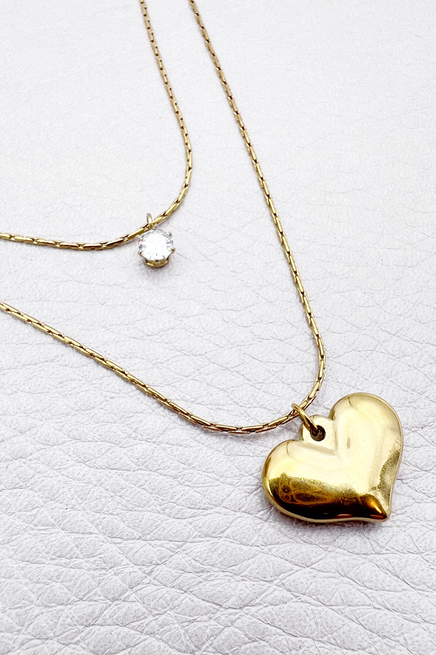 layered gold necklace with cubic zirconia and golden heart