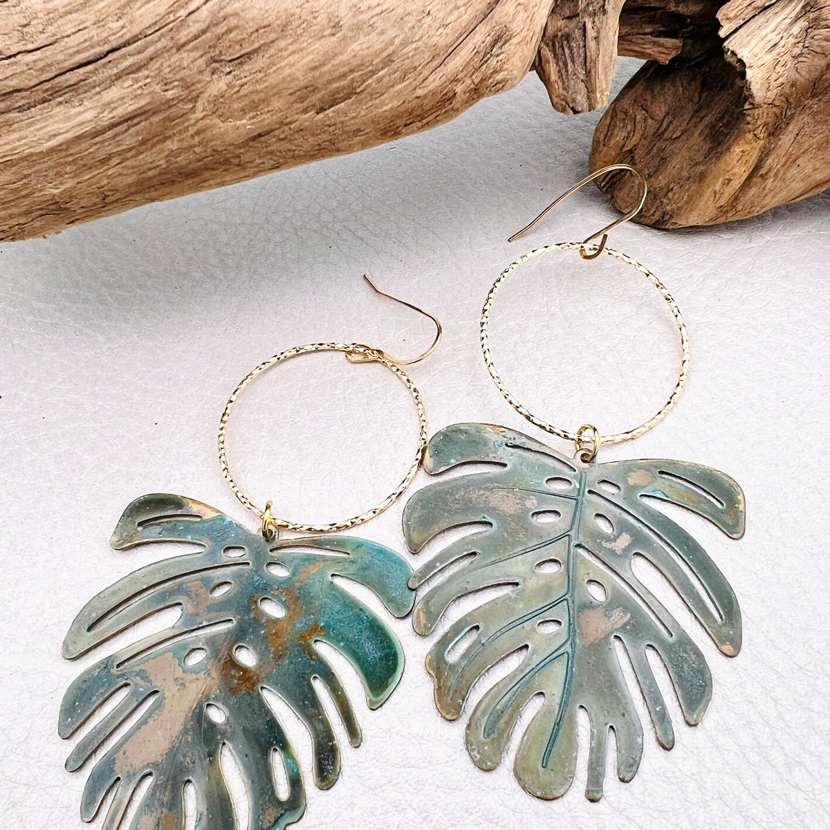 Vivacious modern boho statement jewelry – handcrafted blue patina monstera leaf earrings, a bold and artistic design from Real to the Roots Jewelry. 
