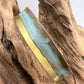 turquoise patina bracelet on a wooden display