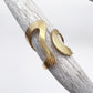 Gold ring on a deer antler with a white background