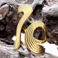 Gold spiral ring on a textured wooden surface