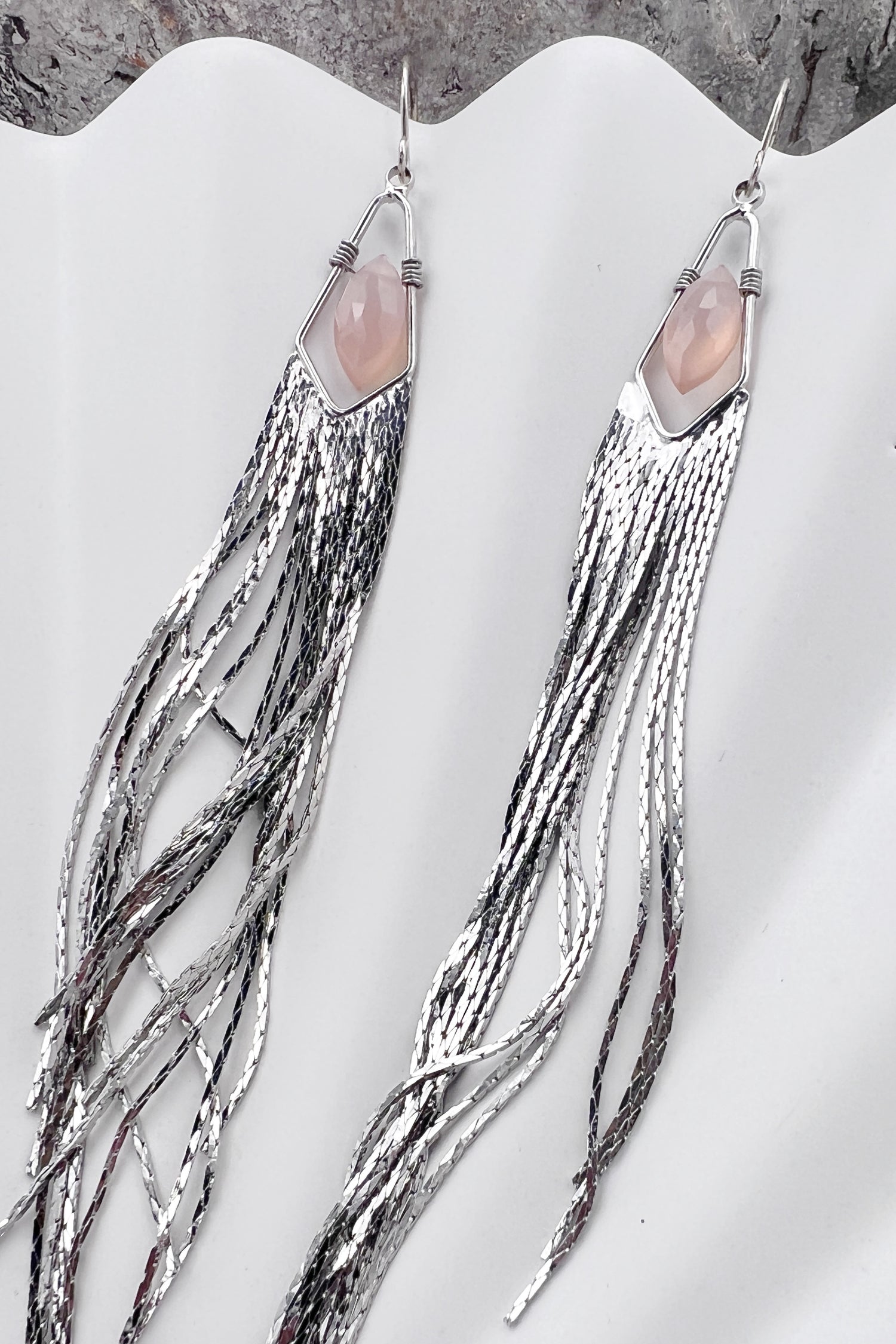 Long gemstone fringe earrings with silver tassels, featuring pink opal. Lightweight and shimmering.
