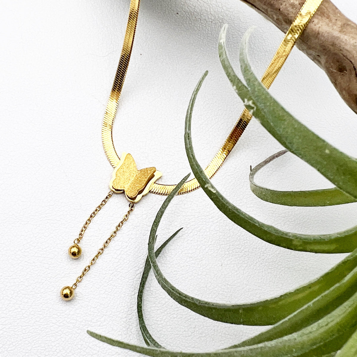 18k gold-plated stainless steel necklace with a butterfly charm, representing the thyroid and transformation. Adjustable 16” chain with 2” extender.